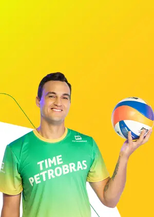 Homem com uma bola de volei na mão e uma camiseta escrito Time Petrobras