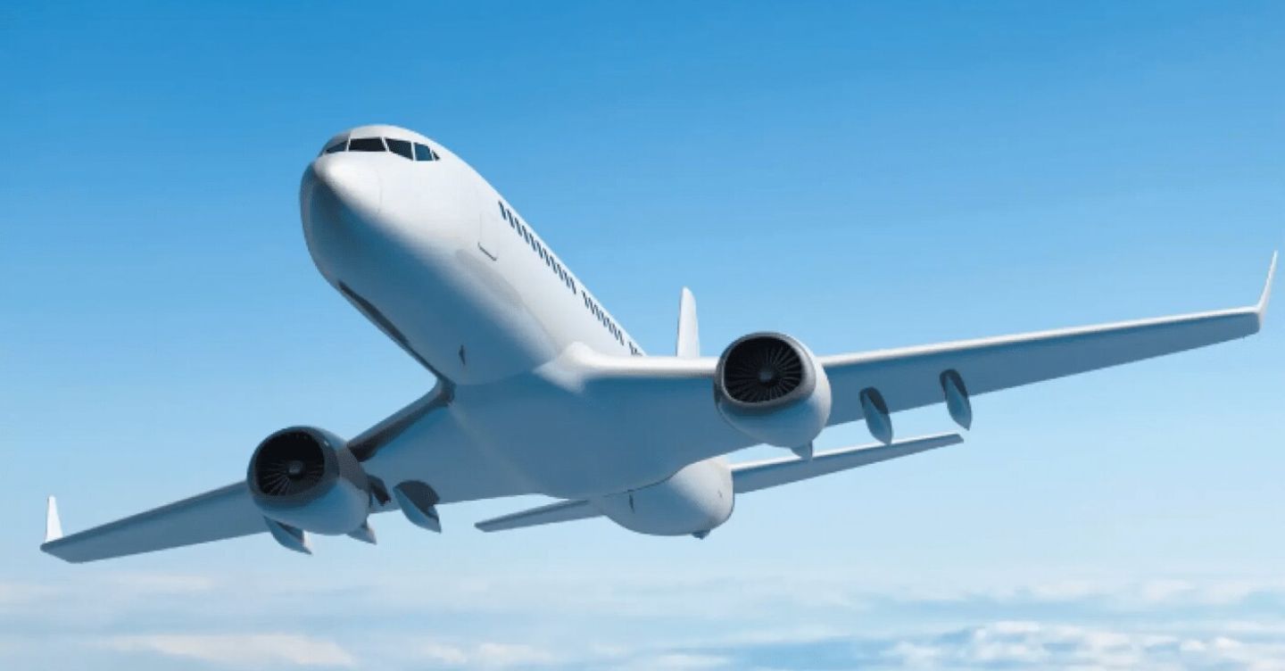 White commercial airplane flying above clouds in a blue sky.