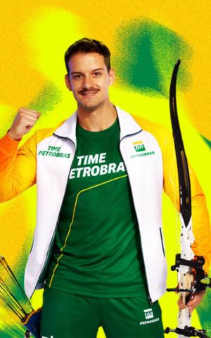 A Petrobras Team athlete poses with a bow and arrows, wearing a green and white sports uniform, in reference to archery.