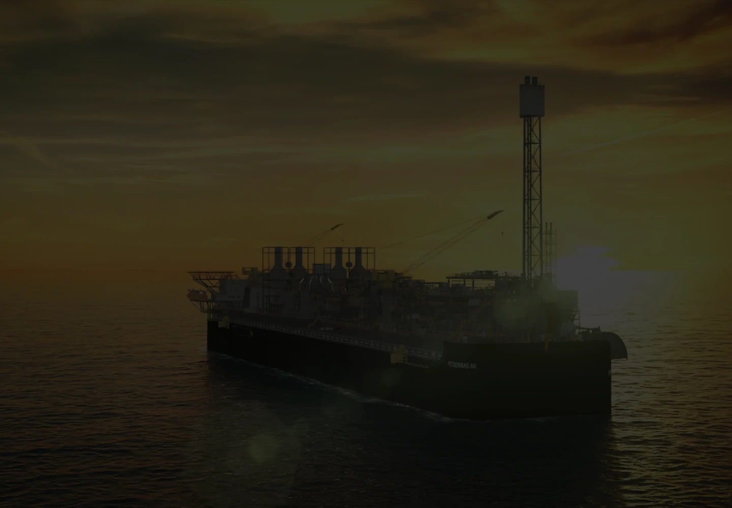 Fotografia de uma plataforma FPSO da Petrobras durante o nascer ou pôr do sol.