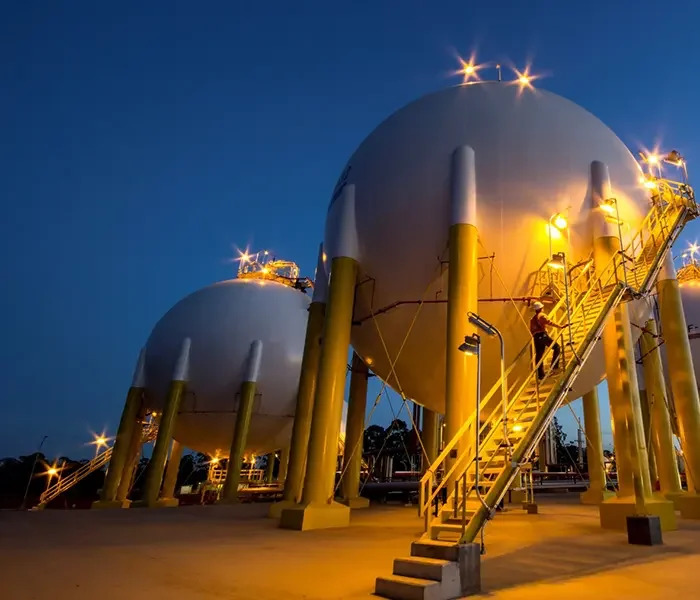 Fotografia noturna de tanques de armazenamento de gás da Petrobras.