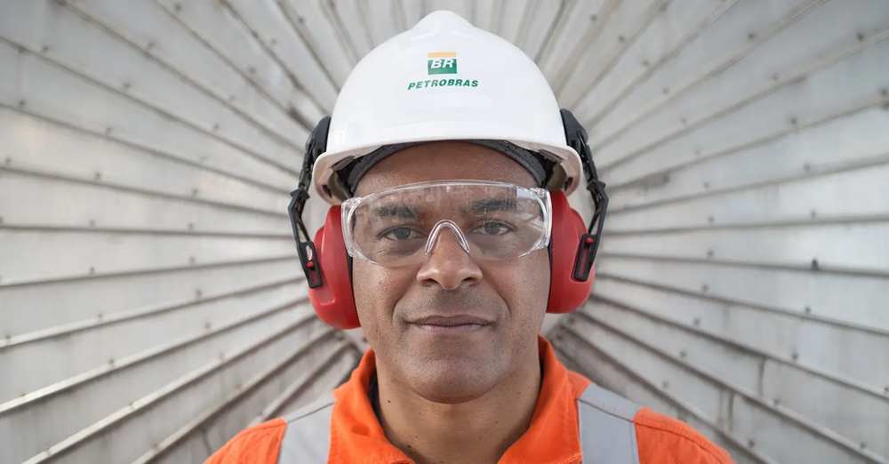 Petrobras employee looks directly at the camera. In their helmet is the Petrobras brand.