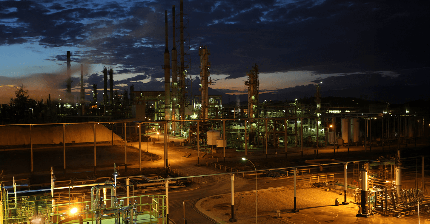 Oil refinery illuminated at night.