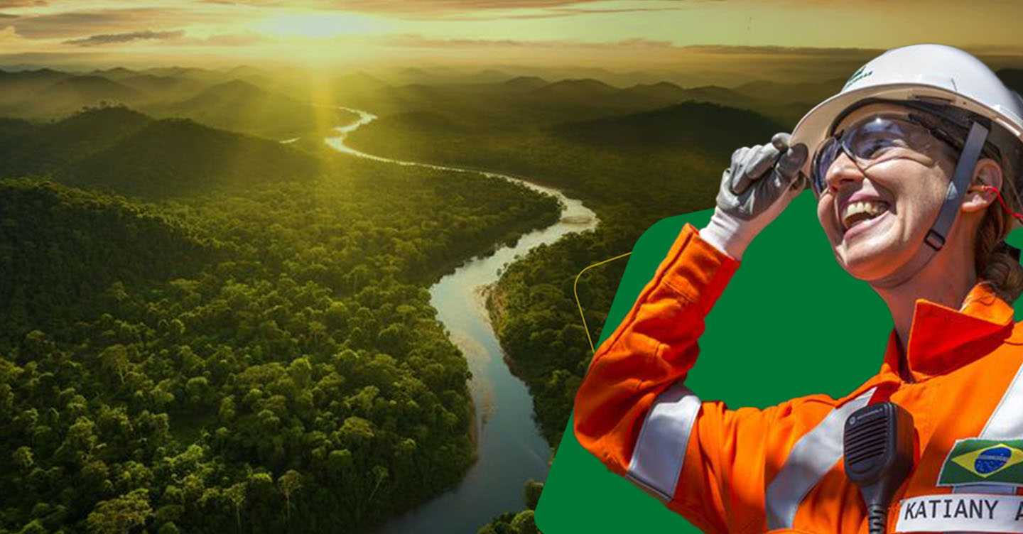 Woman wearing glasses, helmet and Petrobras jumpsuit with forest in the background.