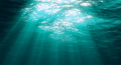 Sunlight filtering through the clear, deep ocean water.