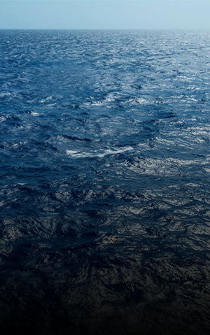 Blue sea with piece of sky and horizon line at the top.