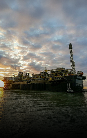 FPSO P68 seen in backlight, at sunset.