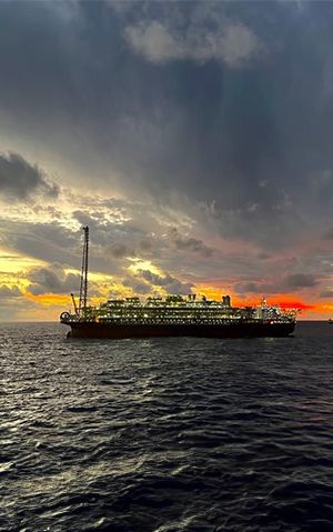 Photo of a platform ship in the middle of the ocean at dusk