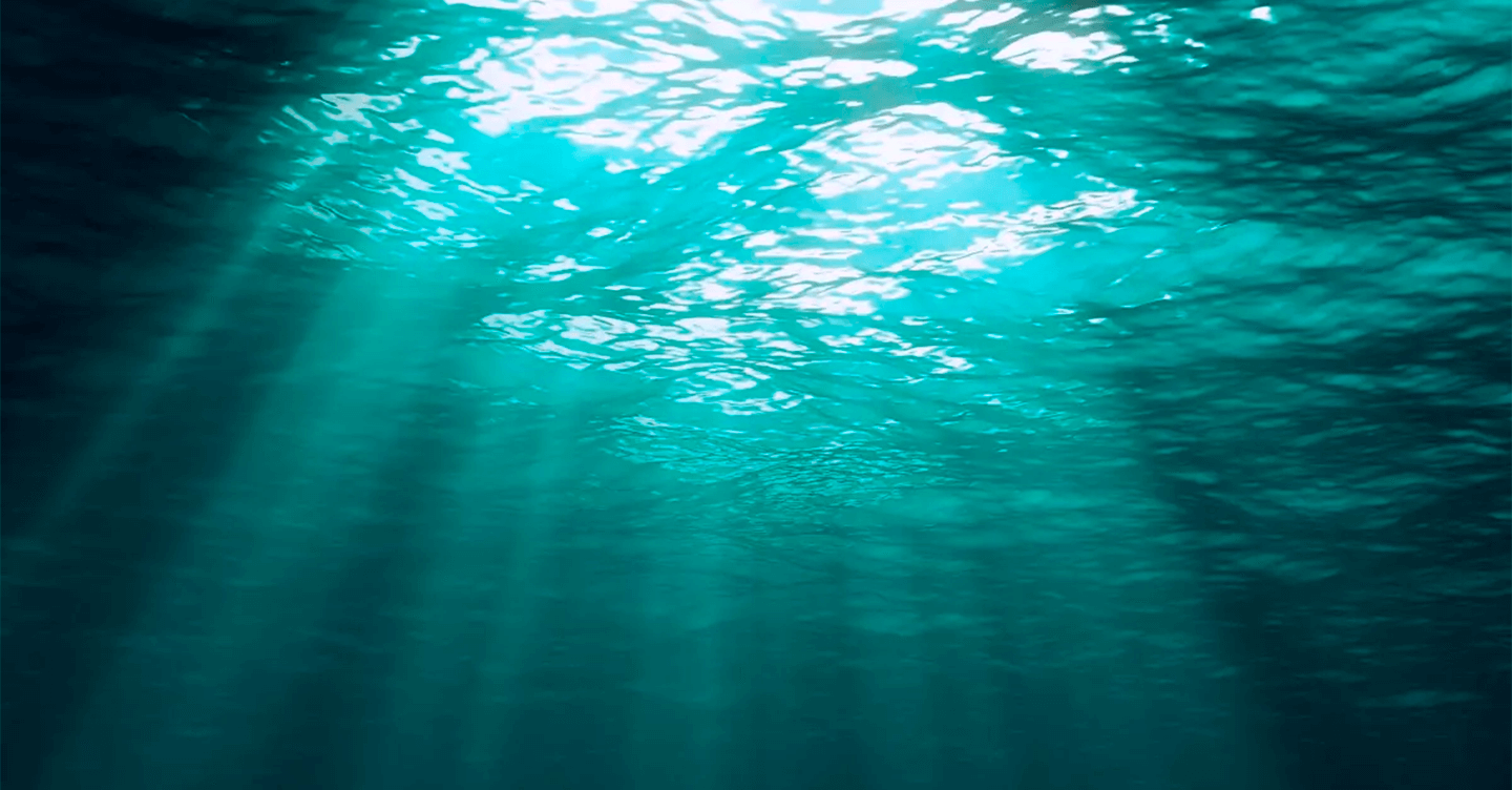 Underwater photograph showing a beam of sunlight entering the sea.