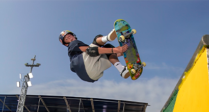 Skateboarding athlete performing a trick on the track.